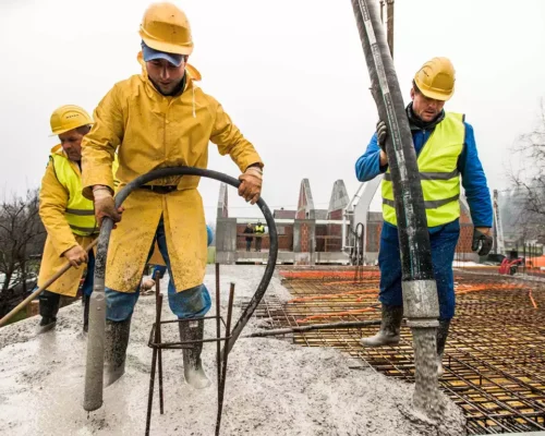 construction-workers-pouring-cement-on-roof
